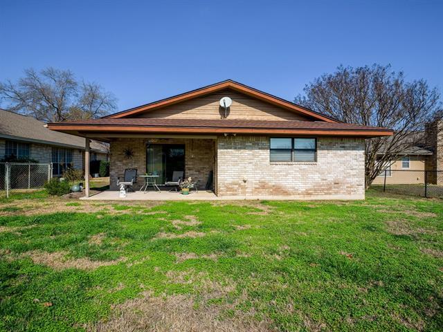 back of house with a patio area, fence, a lawn, and brick siding