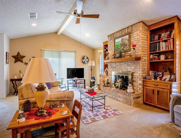 carpeted living room featuring a fireplace, vaulted ceiling with beams, visible vents, a ceiling fan, and a textured ceiling