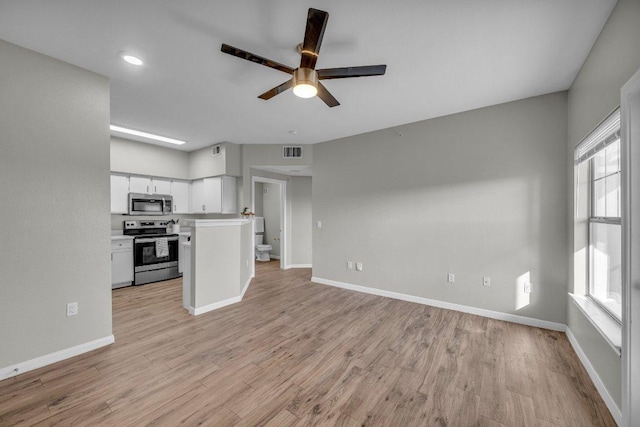 kitchen featuring open floor plan, stainless steel appliances, light wood-type flooring, and visible vents