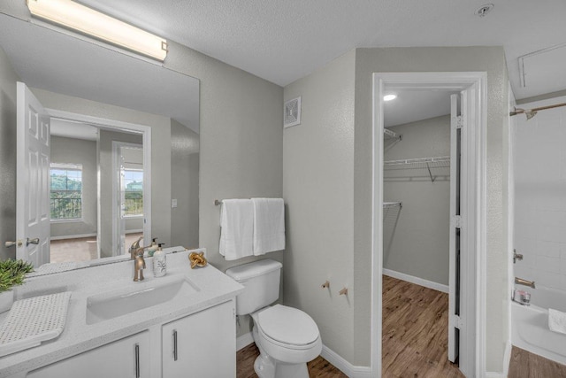 full bath with visible vents, vanity, toilet, and wood finished floors