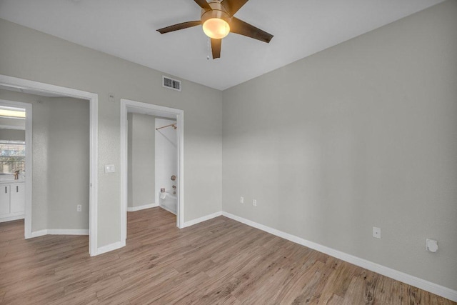 unfurnished bedroom with light wood-style floors, visible vents, baseboards, and a ceiling fan