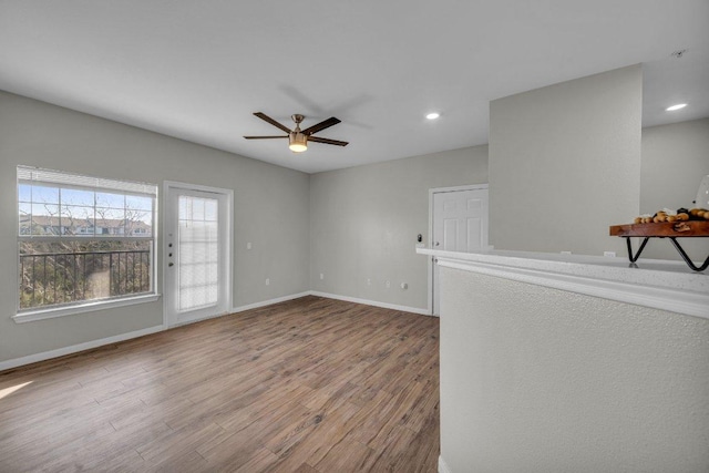 unfurnished room featuring recessed lighting, ceiling fan, baseboards, and wood finished floors