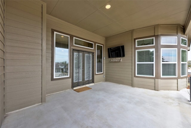 entrance to property featuring french doors and a patio area