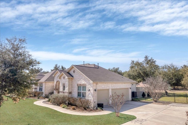 french country home with driveway, a garage, stone siding, fence, and a front yard