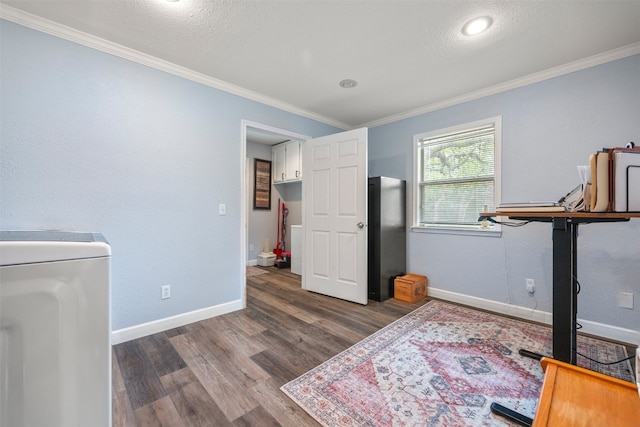 office area featuring baseboards, crown molding, washer / clothes dryer, and wood finished floors