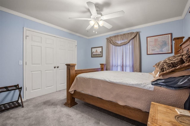 bedroom featuring carpet, a closet, a ceiling fan, and crown molding