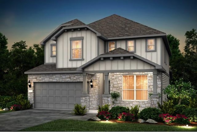 view of front of home featuring board and batten siding, concrete driveway, roof with shingles, and a garage