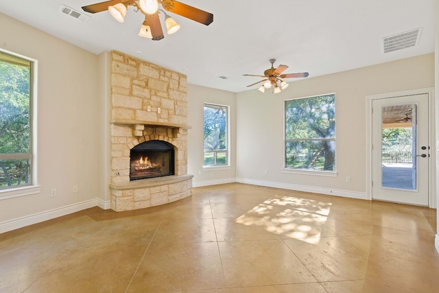 10221 David Moore Dr Unit 1 & 2, Austin, TX 78748 - unfurnished living room featuring a ceiling fan, plenty of natural light, and a fireplace