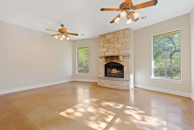 10221 David Moore Dr Unit 1 & 2, Austin, TX 78748 - unfurnished living room with plenty of natural light, a stone fireplace, baseboards, and ceiling fan