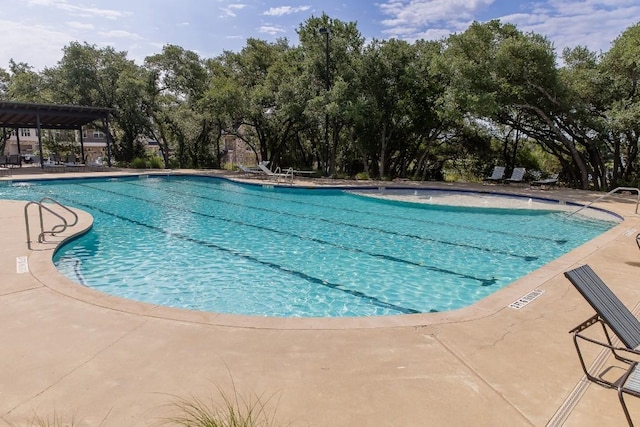 1408 Jolie Rose Bnd, Leander, TX 78641 - community pool with view of scattered trees and a patio area