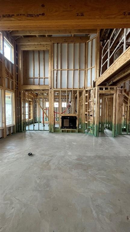 1408 Jolie Rose Bnd, Leander, TX 78641 - miscellaneous room with a towering ceiling and unfinished concrete flooring