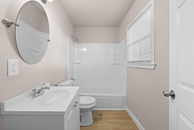 full bathroom featuring shower / bathing tub combination, toilet, vanity, wood finished floors, and baseboards