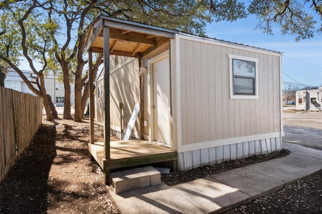 view of outbuilding featuring fence