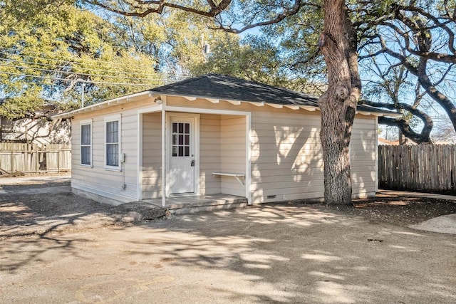 exterior space featuring fence and an outdoor structure