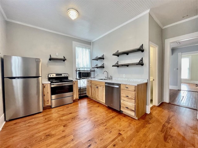 908 W Hopkins St, San Marcos, TX 78666 - kitchen featuring stainless steel appliances, open shelves, light wood-style flooring, light countertops, and ornamental molding