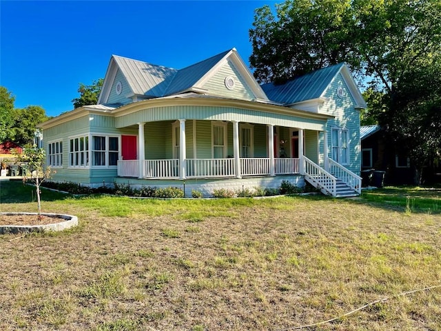 908 W Hopkins St, San Marcos, TX 78666 - view of front of home with covered porch, metal roof, and a front yard