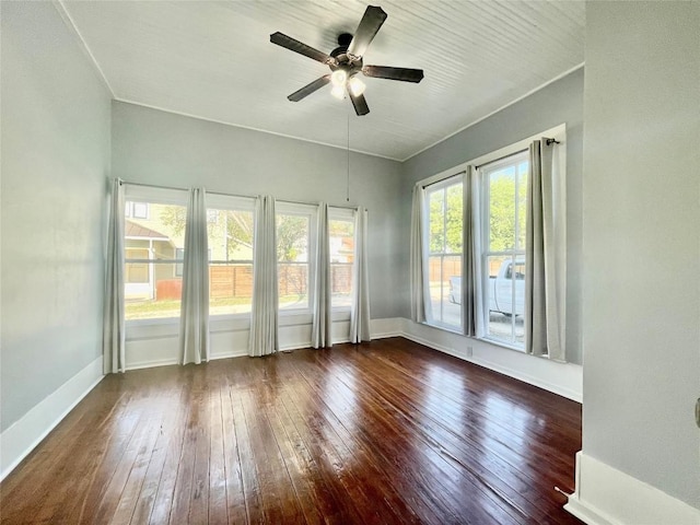 908 W Hopkins St, San Marcos, TX 78666 - empty room with dark wood finished floors, ceiling fan, and baseboards