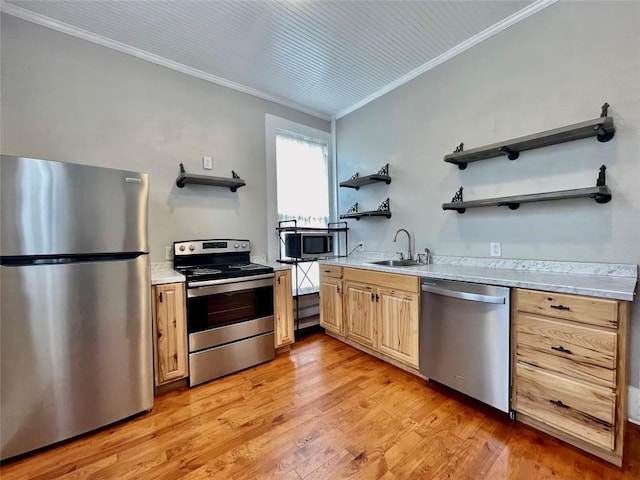 908 W Hopkins St, San Marcos, TX 78666 - kitchen with appliances with stainless steel finishes, open shelves, a sink, ornamental molding, and light wood finished floors