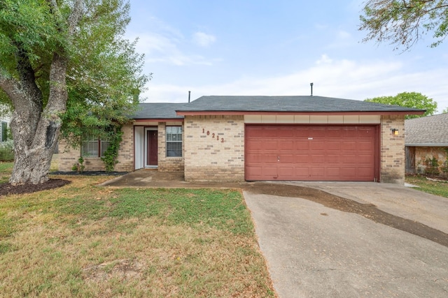 10212 W Rutland Vlg, Austin, TX 78758 - ranch-style house with brick siding, a garage, concrete driveway, and a front lawn