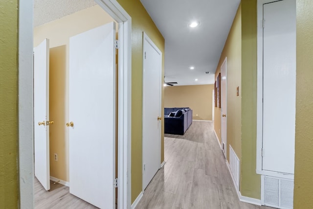 10212 W Rutland Vlg, Austin, TX 78758 - hall featuring light wood-style flooring, recessed lighting, and baseboards