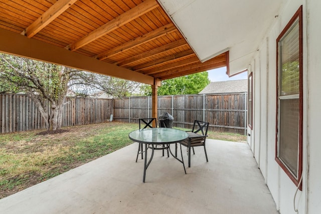 view of patio featuring a fenced backyard and outdoor dining area