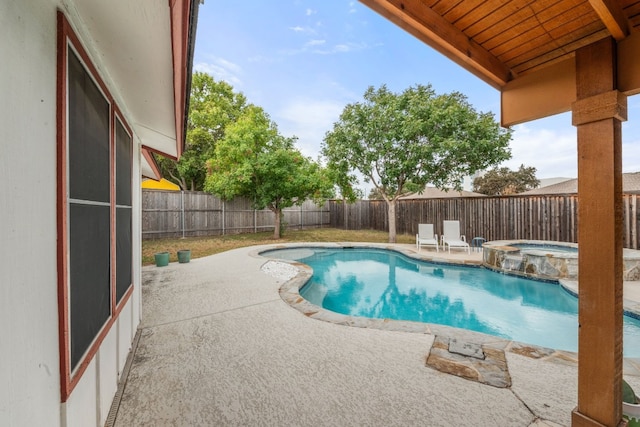 view of pool with a patio, a fenced backyard, and a pool with connected hot tub