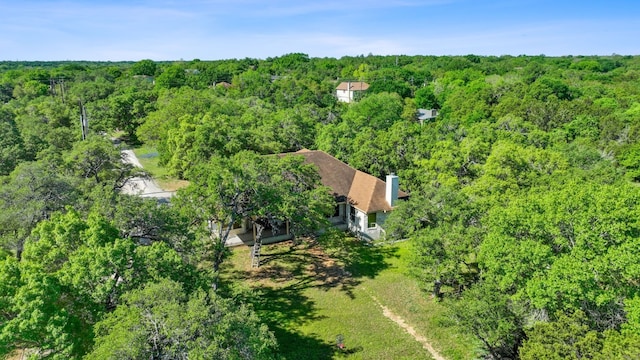 bird's eye view featuring a wooded view