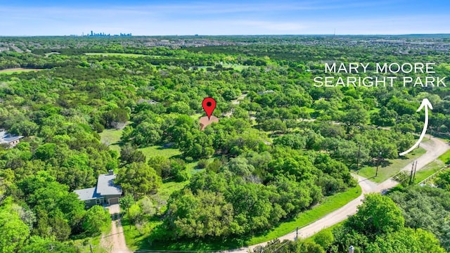 birds eye view of property featuring a wooded view