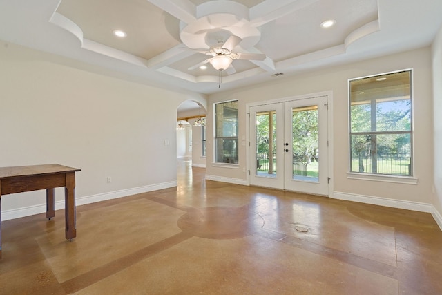 unfurnished living room featuring arched walkways, coffered ceiling, baseboards, and recessed lighting