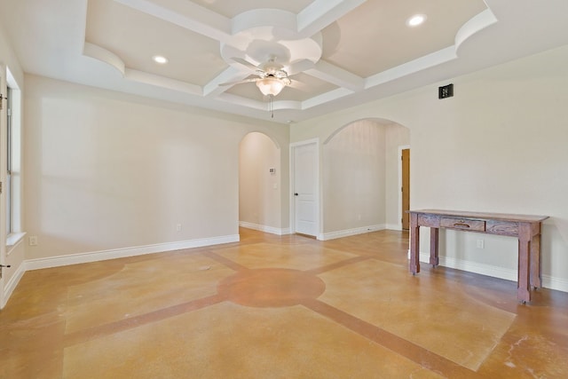 spare room with ceiling fan, arched walkways, and baseboards