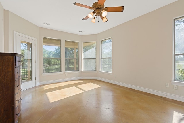 unfurnished room featuring a healthy amount of sunlight, visible vents, and baseboards