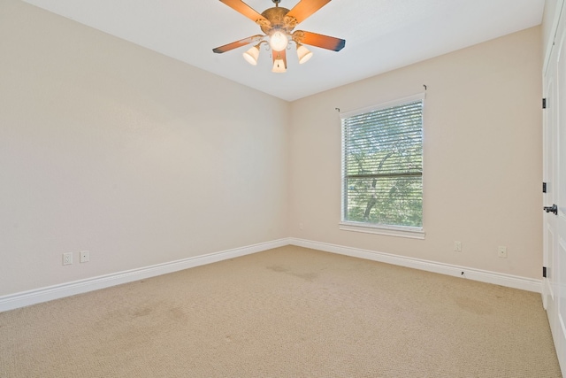 unfurnished room with a ceiling fan, light colored carpet, and baseboards