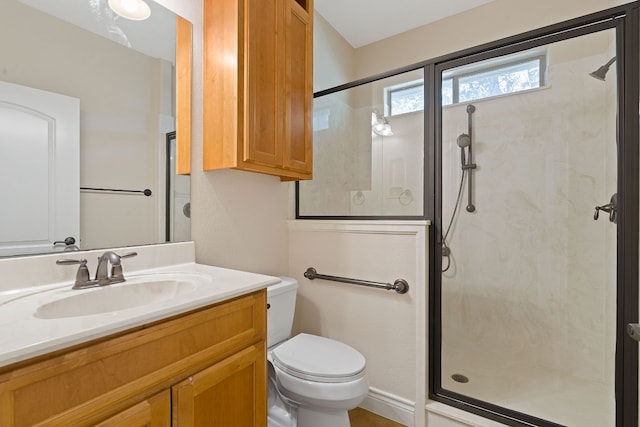 bathroom featuring a stall shower, vanity, and toilet