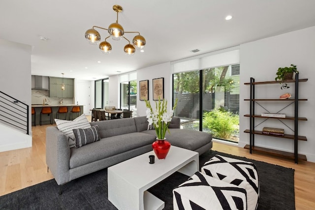 1706 Goodrich Ave Unit A, Austin, TX 78704 - living area with wood finished floors, plenty of natural light, a chandelier, recessed lighting, and floor to ceiling windows