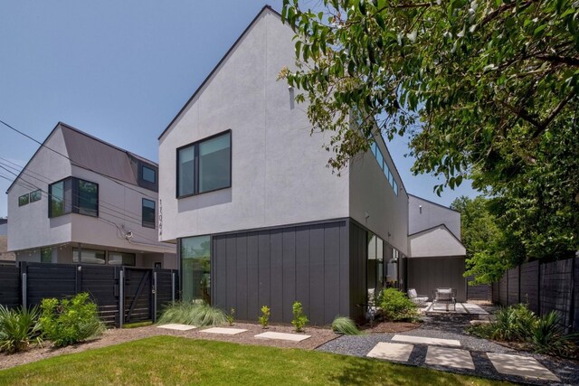 1706 Goodrich Ave Unit A, Austin, TX 78704 - rear view of house featuring stucco siding and a patio area