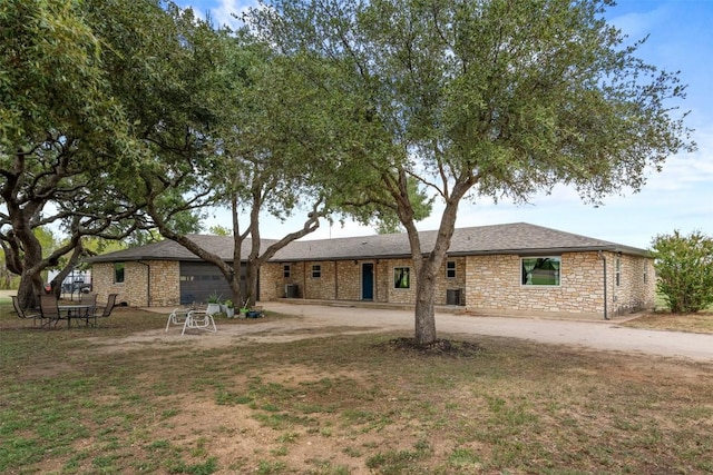 back of property featuring a garage and a lawn