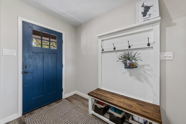 mudroom with dark wood-style floors and baseboards