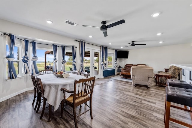 dining area featuring baseboards, visible vents, wood finished floors, french doors, and recessed lighting