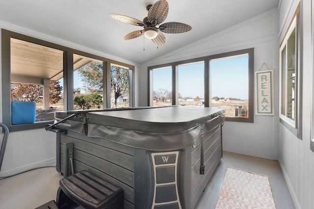 sunroom featuring vaulted ceiling, plenty of natural light, a ceiling fan, and a hot tub