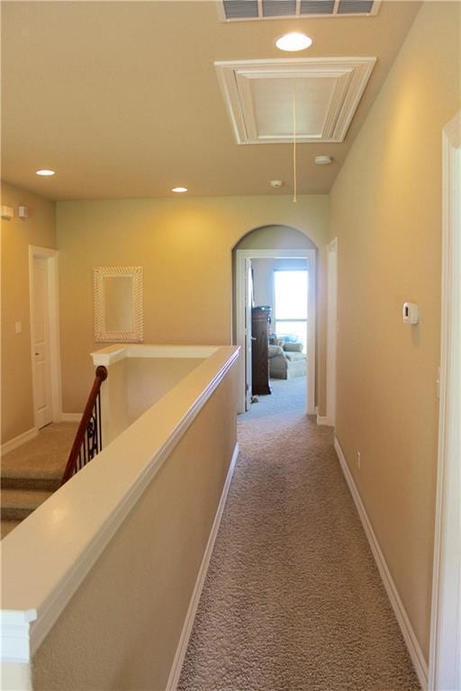 hallway with recessed lighting, attic access, light carpet, an upstairs landing, and baseboards