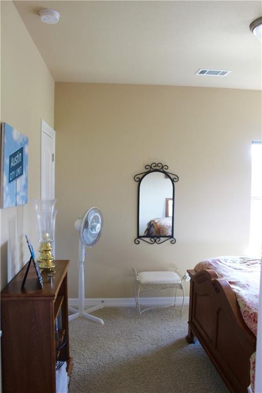 carpeted bedroom with visible vents and baseboards