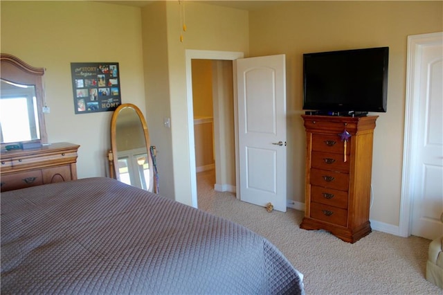 carpeted bedroom featuring baseboards