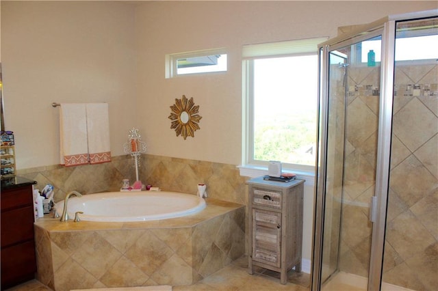 bathroom featuring a shower stall, a bath, and tile patterned floors