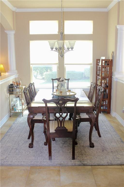 dining room featuring ornamental molding, a healthy amount of sunlight, and a notable chandelier