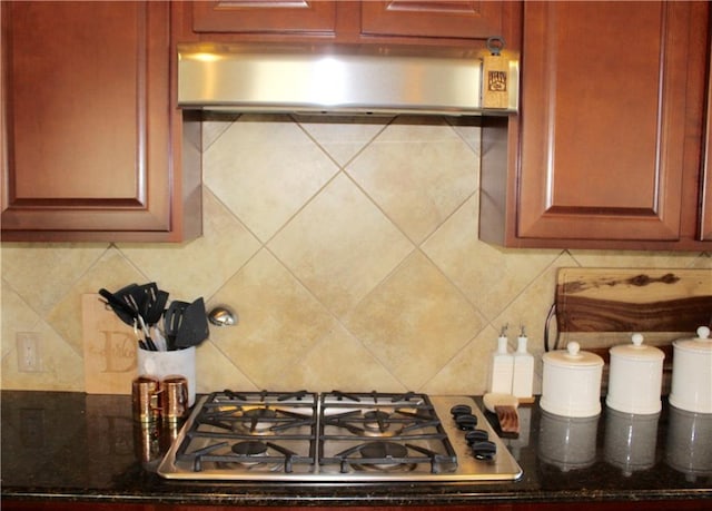 kitchen with stainless steel gas cooktop, extractor fan, and decorative backsplash