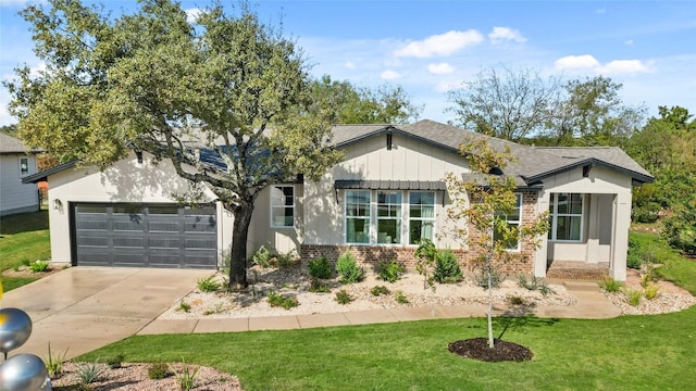 single story home with a garage, driveway, brick siding, and a front yard