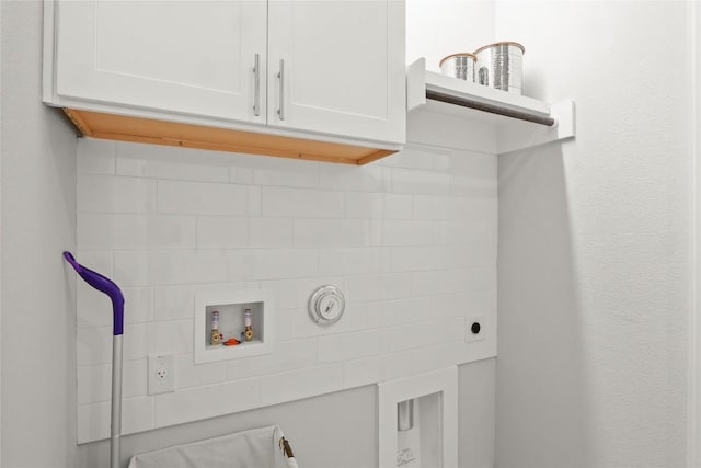 laundry room featuring washer hookup and cabinet space