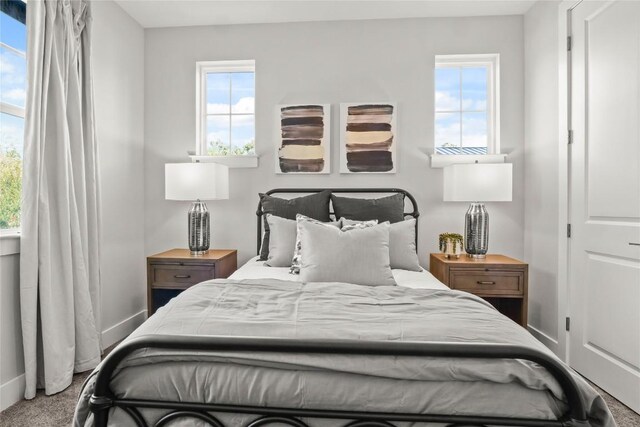 carpeted bedroom featuring baseboards