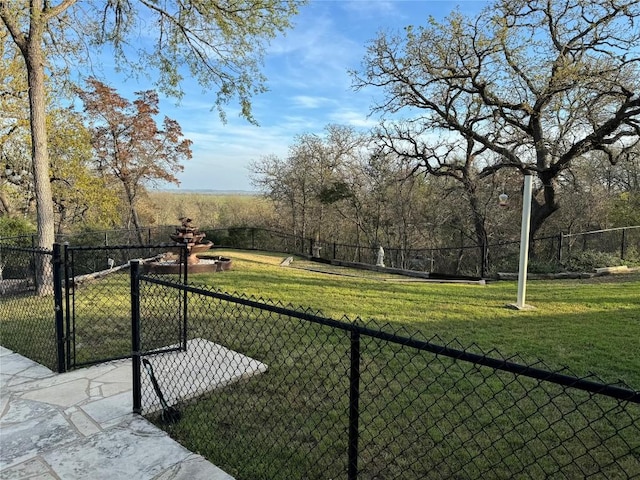 view of property's community with a yard, fence, and a gate