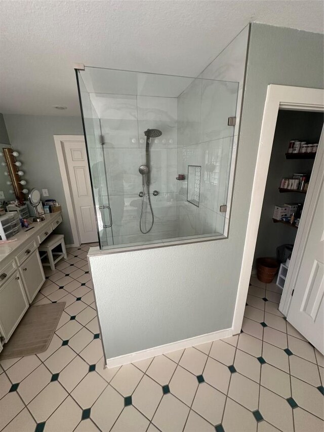 417 Akaloa Dr, Bastrop, TX 78602 - bathroom featuring a textured ceiling, a stall shower, and baseboards